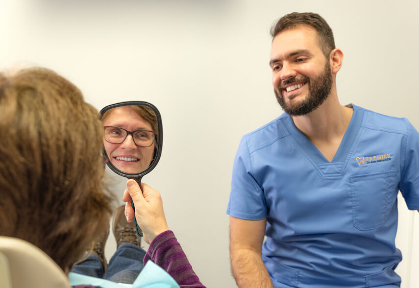 Our cosmetic dentist showing patient their new dental implants in Rocklin, CA